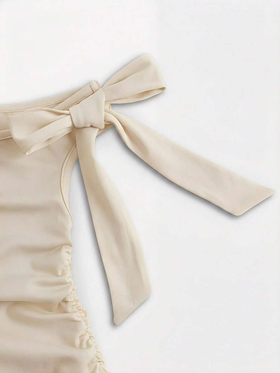 Tween girl wearing an apricot asymmetrical tiered sleeveless party dress with an A-line silhouette.