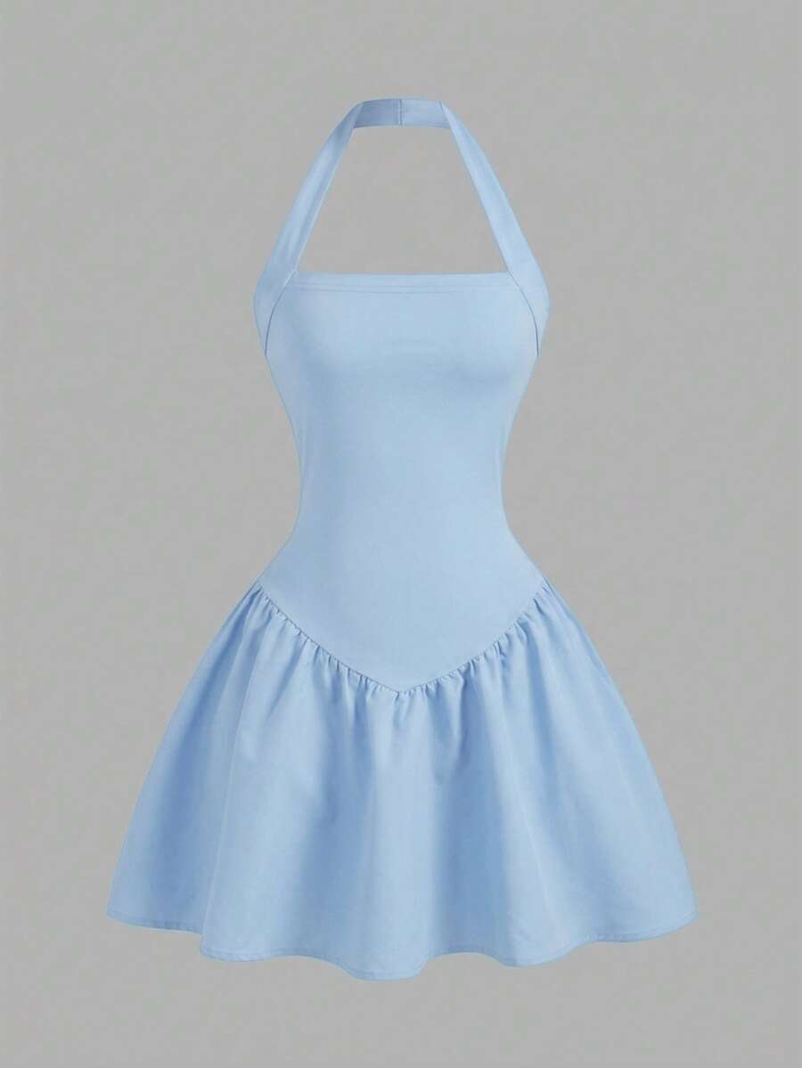 Black sleeveless halter polka dot mini dress for tween girls featuring a high waist and flared hem