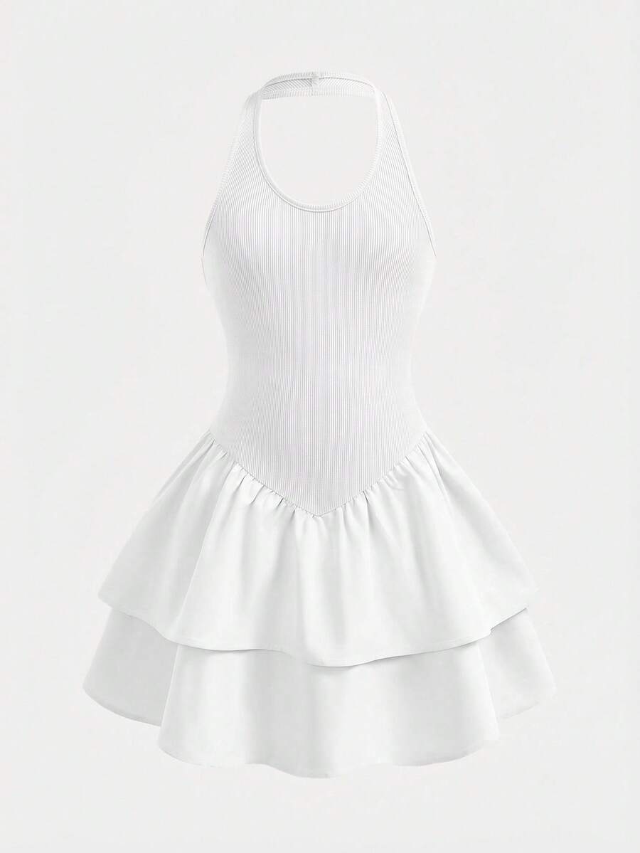 Black sleeveless halter polka dot mini dress for tween girls featuring a high waist and flared hem