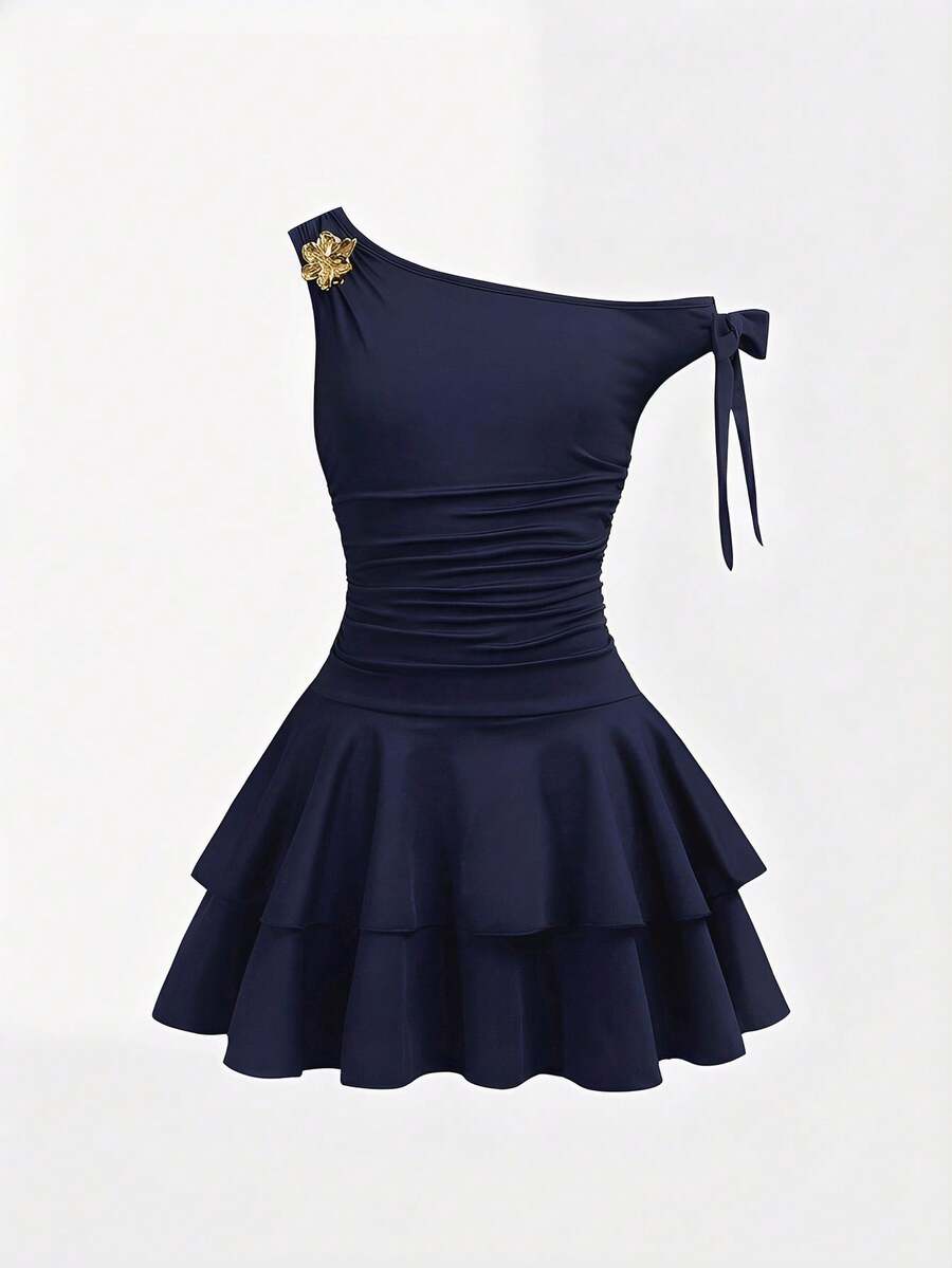 Tween girl wearing an apricot asymmetrical tiered sleeveless party dress with an A-line silhouette.