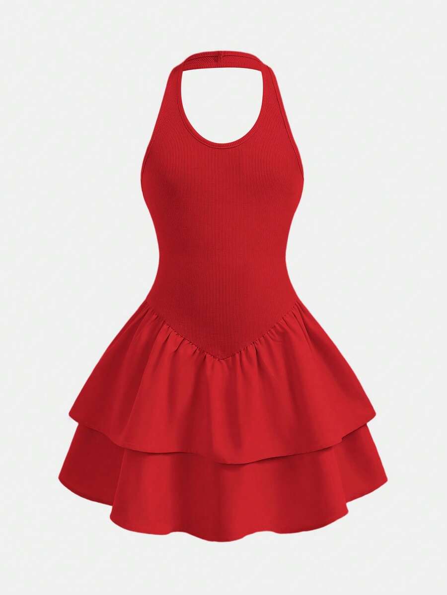 Black sleeveless halter polka dot mini dress for tween girls featuring a high waist and flared hem