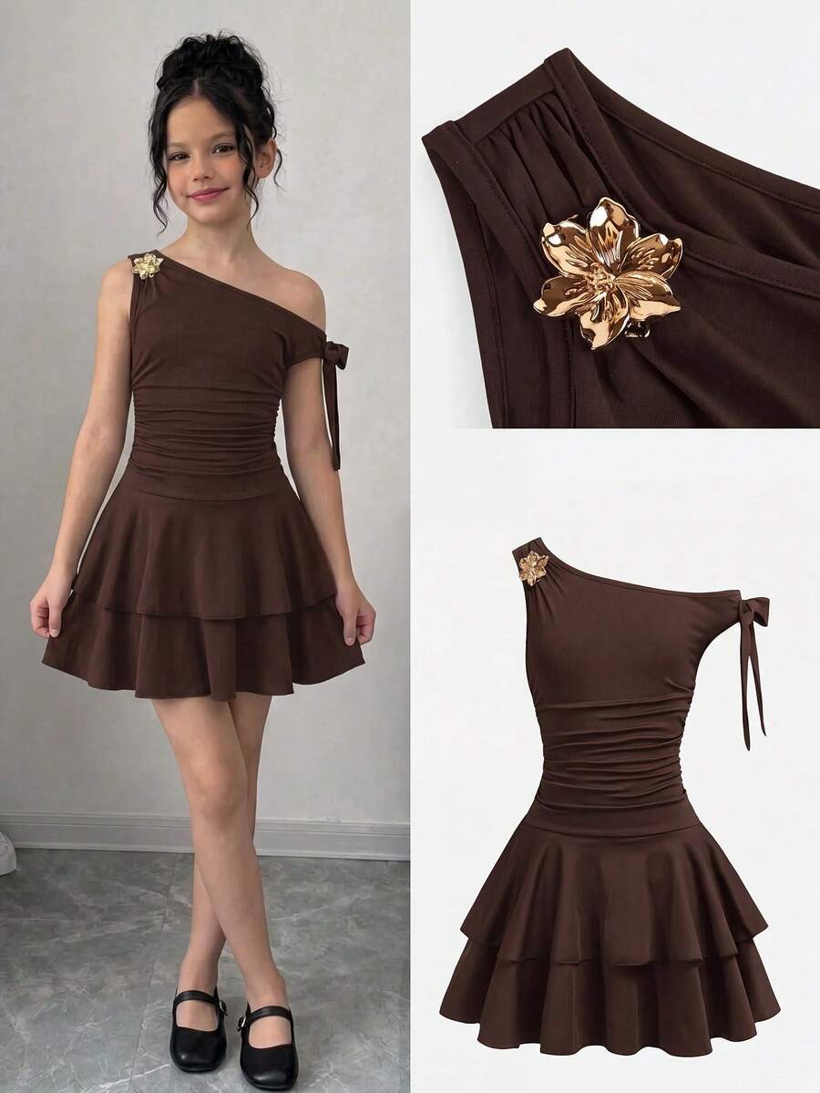 Tween girl wearing an apricot asymmetrical tiered sleeveless party dress with an A-line silhouette.