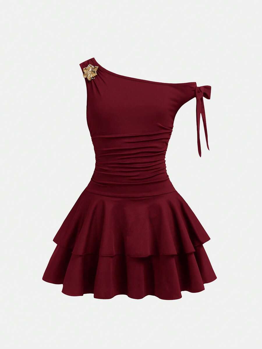 Tween girl wearing an apricot asymmetrical tiered sleeveless party dress with an A-line silhouette.