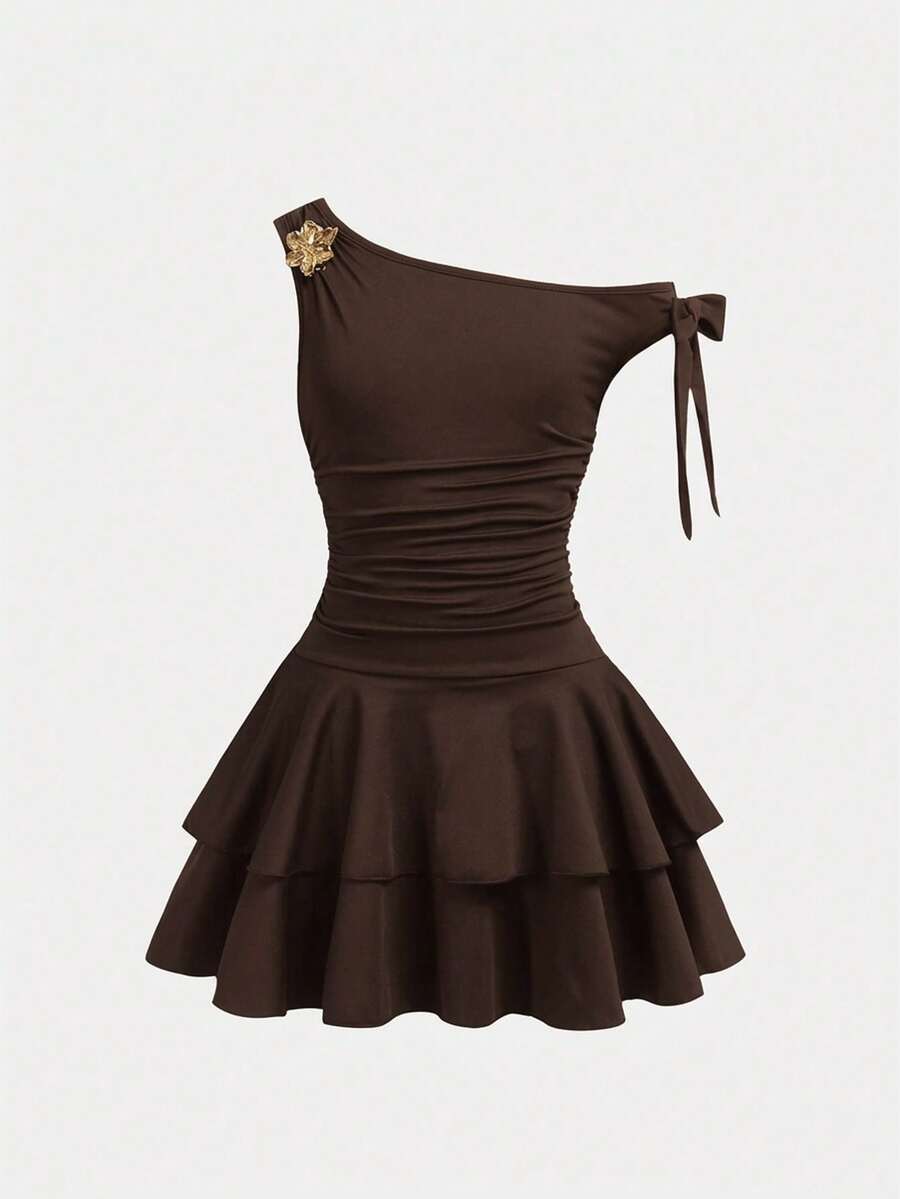 Tween girl wearing an apricot asymmetrical tiered sleeveless party dress with an A-line silhouette.