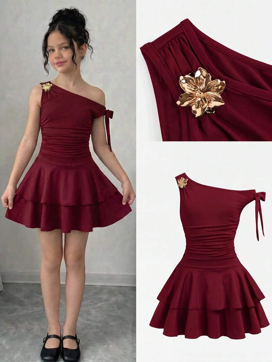 Tween girl wearing an apricot asymmetrical tiered sleeveless party dress with an A-line silhouette.