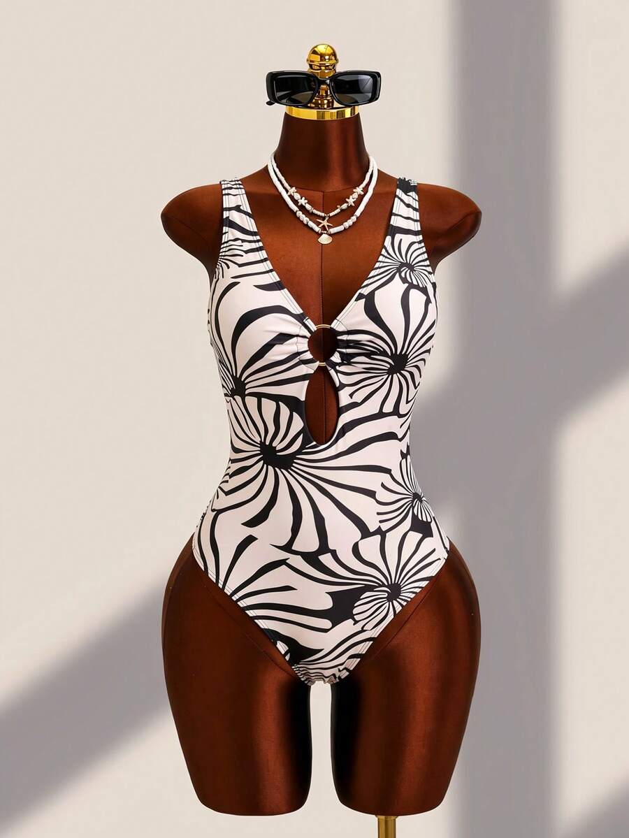 Women's black floral print plunge neck one-piece swimsuit featuring cut-out detail paired with a matching knee-length mesh cover-up skirt