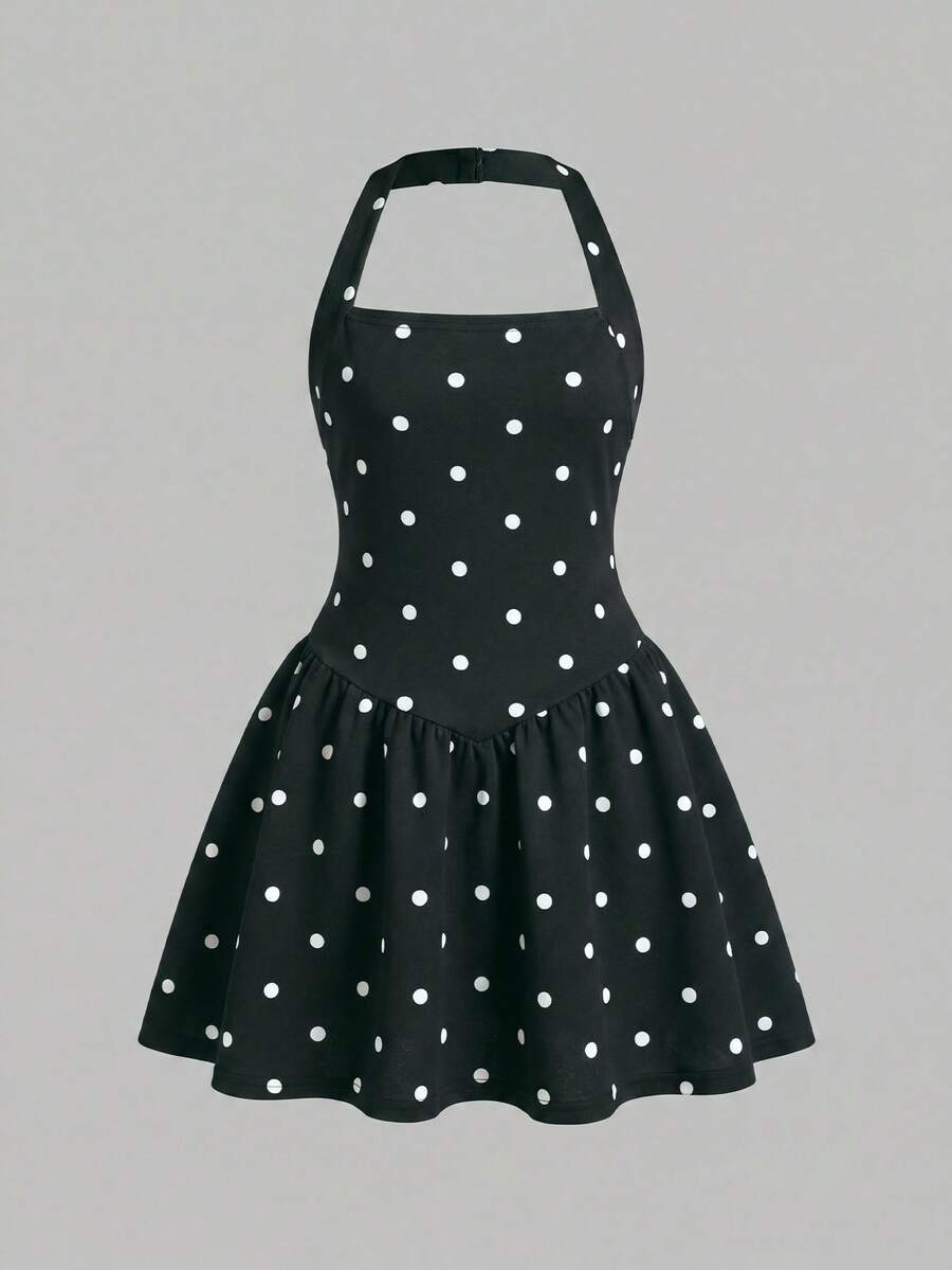 Black sleeveless halter polka dot mini dress for tween girls featuring a high waist and flared hem