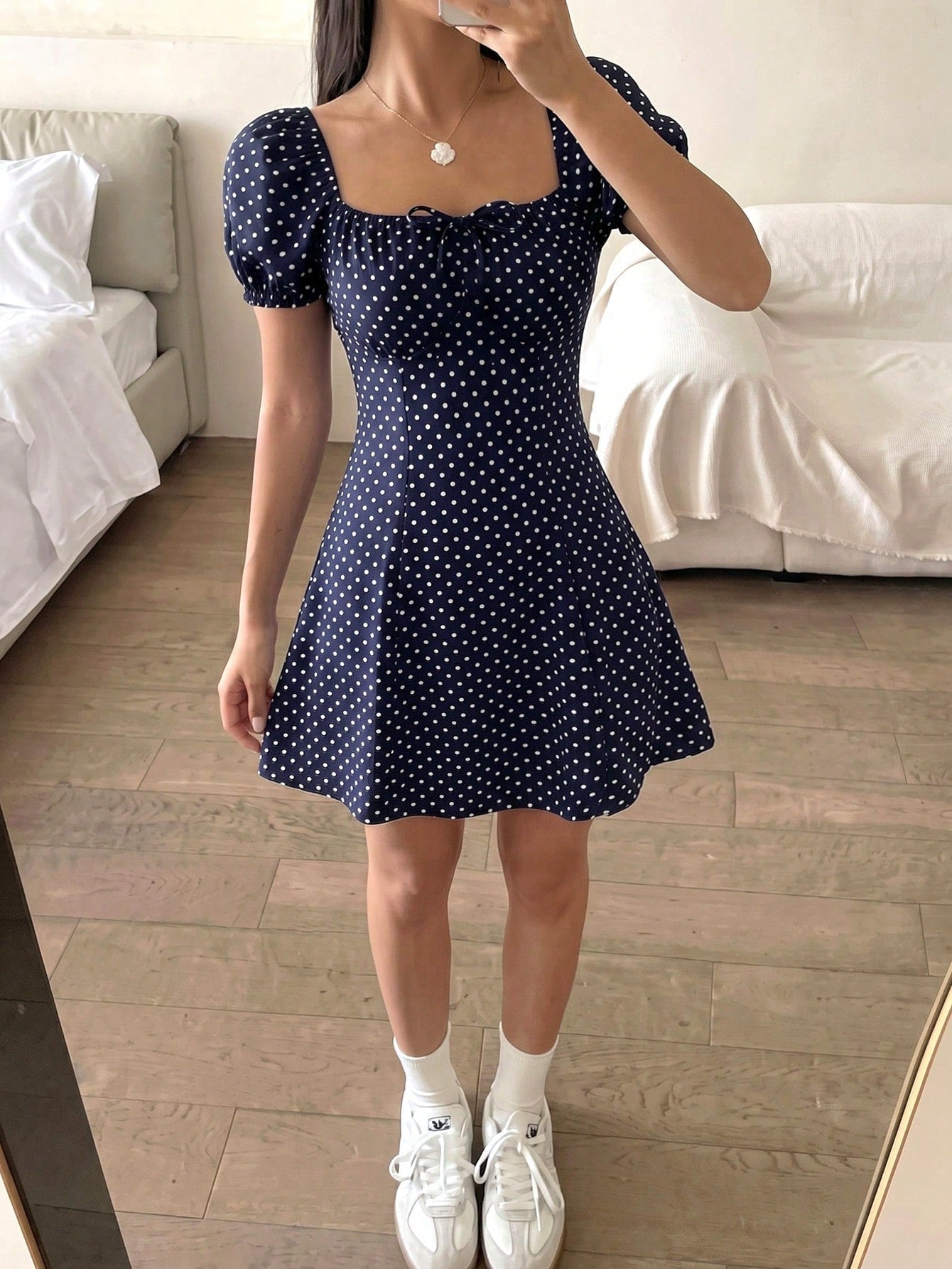 Black floral all-over print midi dress for tween girls featuring puff half sleeves, spaghetti strap neckline, and an A-line silhouette.
