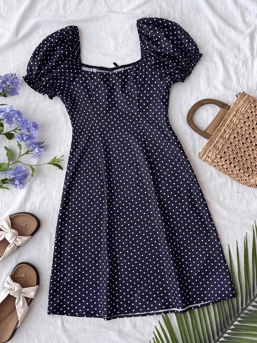 Black floral all-over print midi dress for tween girls featuring puff half sleeves, spaghetti strap neckline, and an A-line silhouette.
