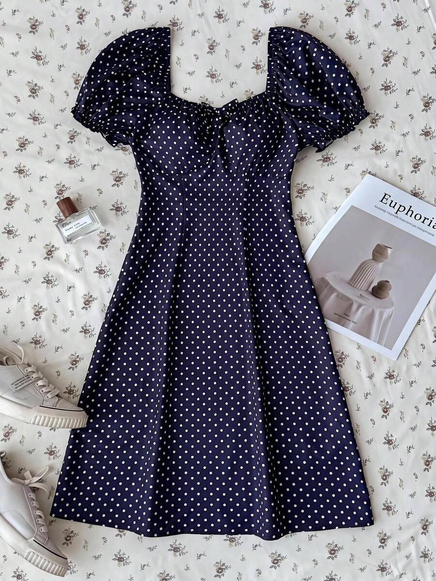 Black floral all-over print midi dress for tween girls featuring puff half sleeves, spaghetti strap neckline, and an A-line silhouette.