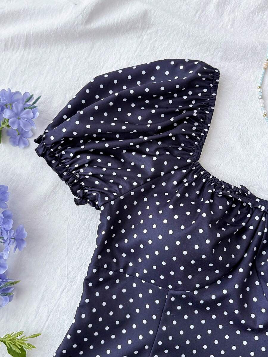 Black floral all-over print midi dress for tween girls featuring puff half sleeves, spaghetti strap neckline, and an A-line silhouette.