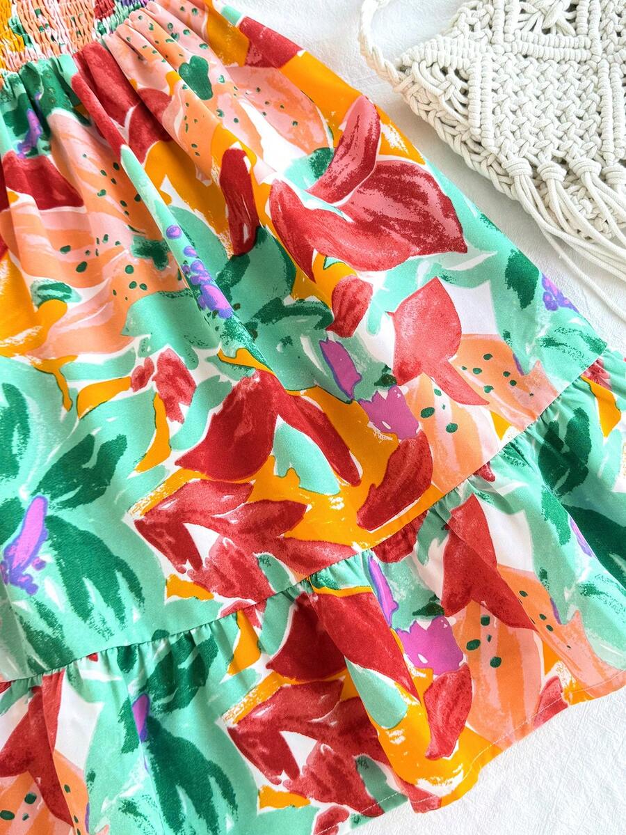 Pink sleeveless tween girls vacation dress with all-over fruit and vegetable print, strap neckline, belted high waist, cut-out detail, and flared ruffle hem.