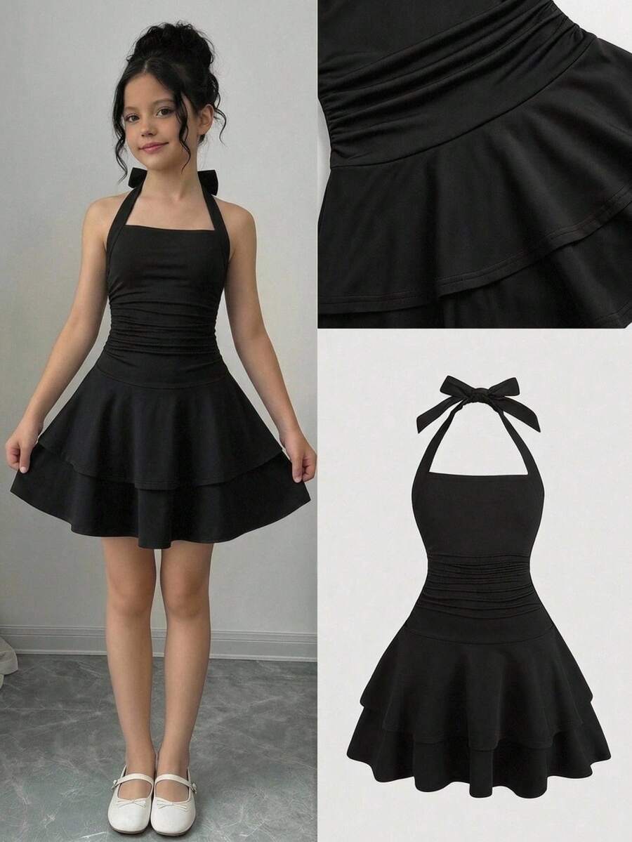 Black sleeveless halter polka dot mini dress for tween girls featuring a high waist and flared hem