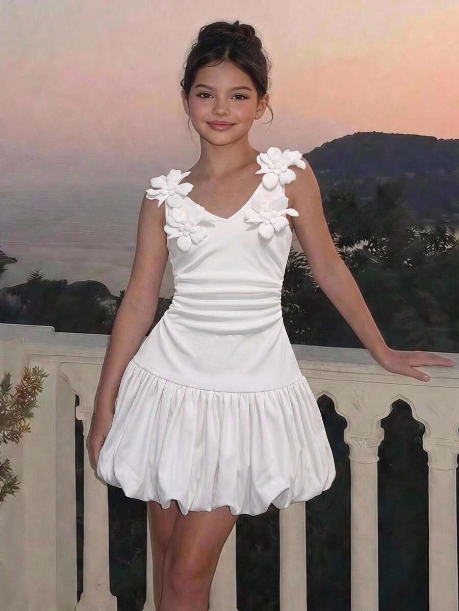 Black and white polka dot cami dress for tween girls featuring a square neckline, high waist, and flared short A-line hem.