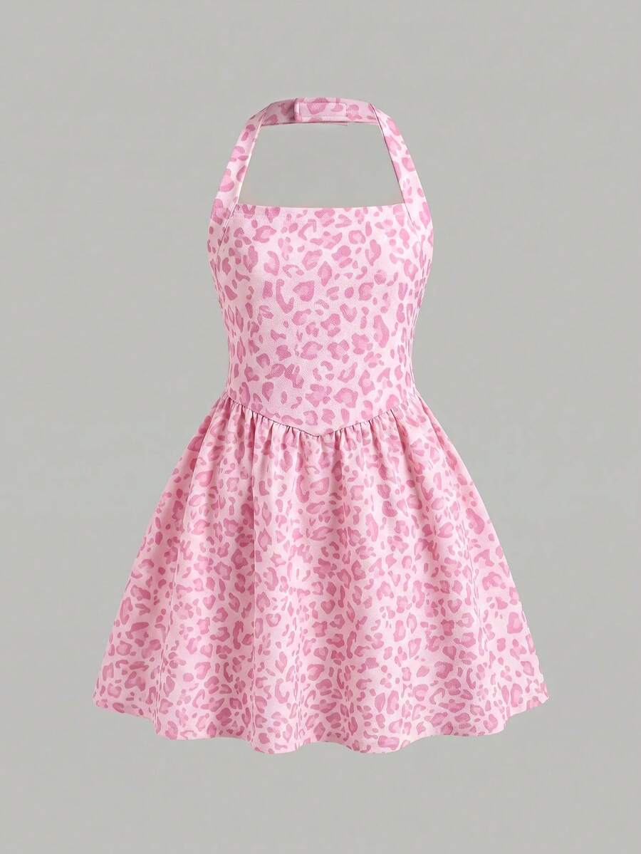 Black sleeveless halter polka dot mini dress for tween girls featuring a high waist and flared hem