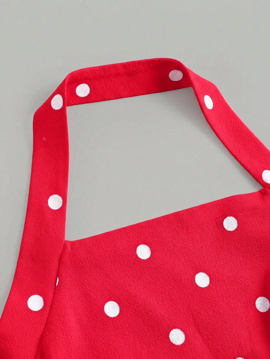 Black sleeveless halter polka dot mini dress for tween girls featuring a high waist and flared hem