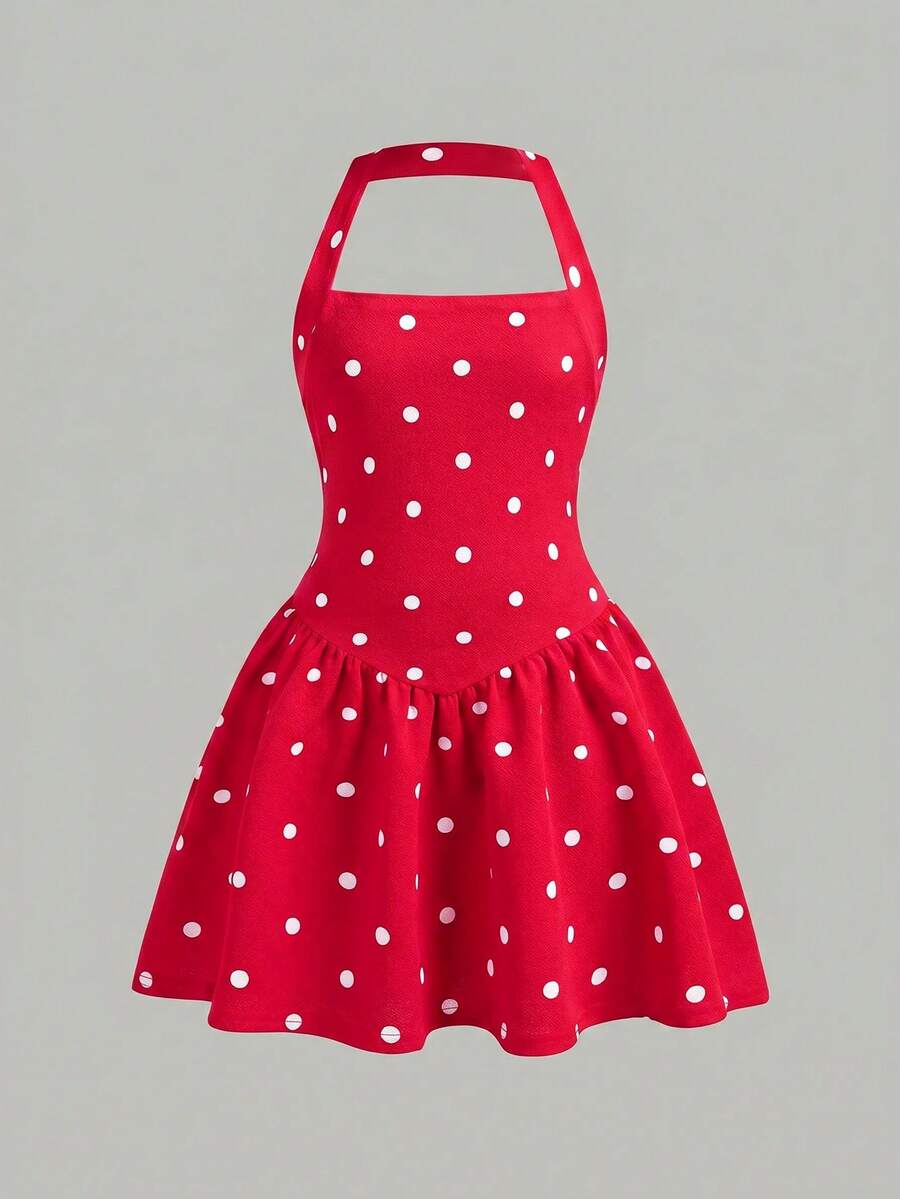 Black sleeveless halter polka dot mini dress for tween girls featuring a high waist and flared hem