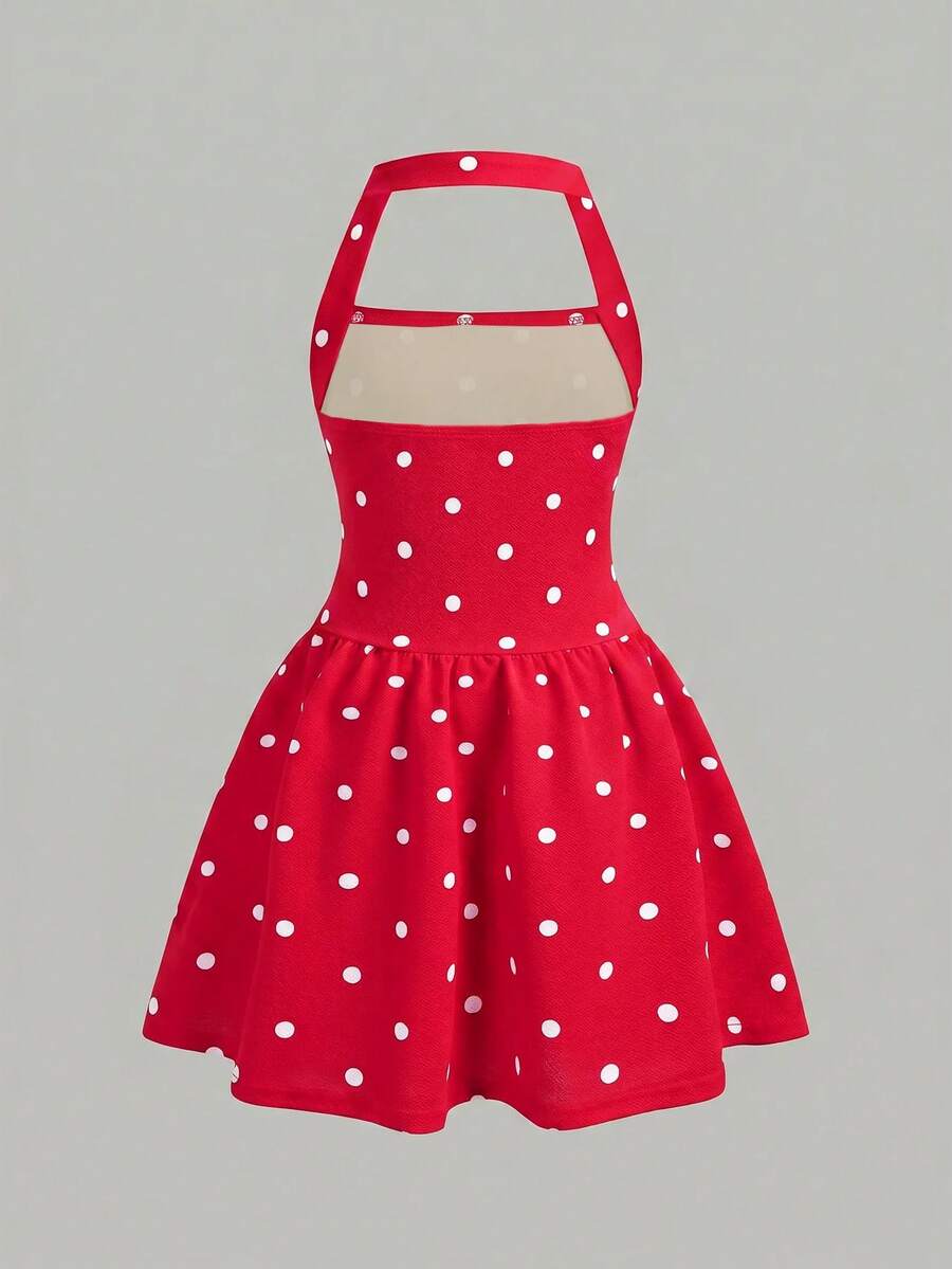 Black sleeveless halter polka dot mini dress for tween girls featuring a high waist and flared hem