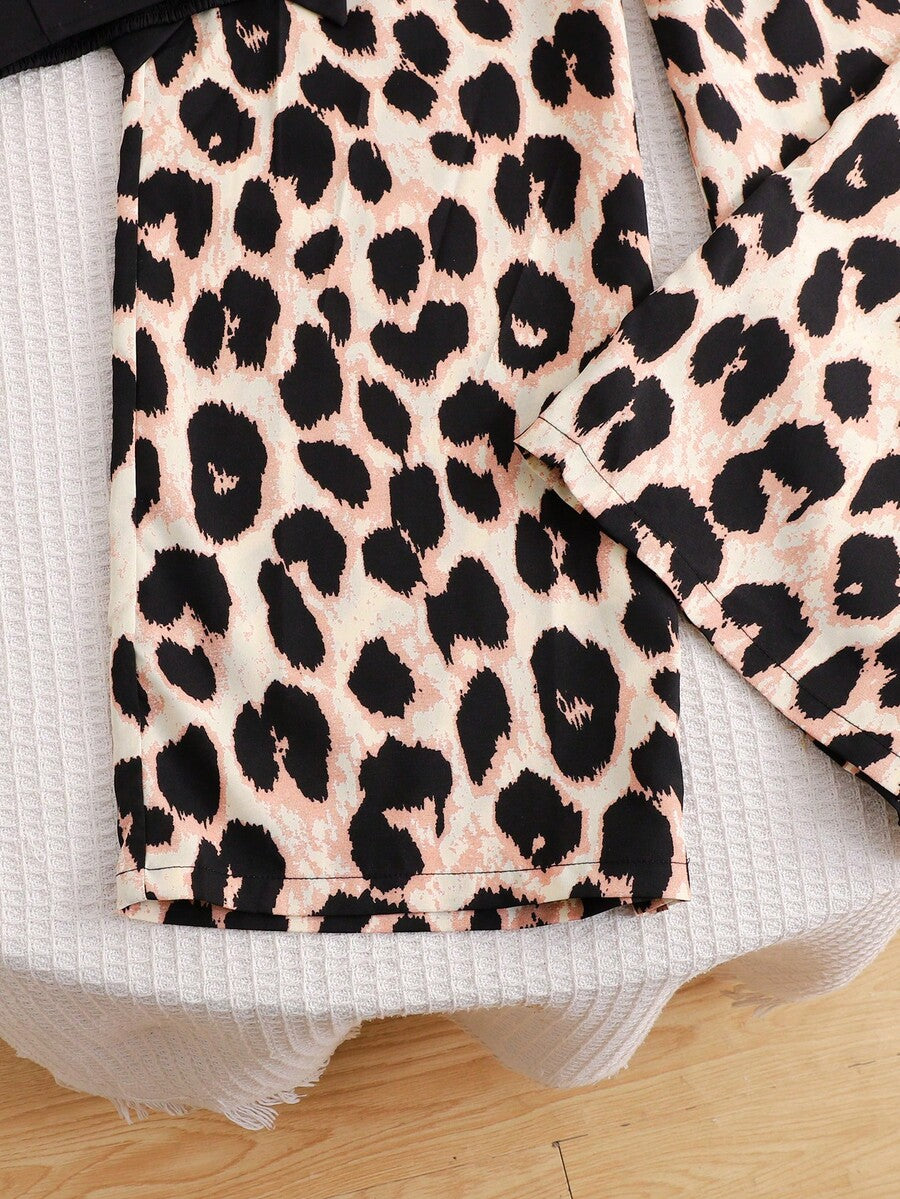 Tween girl wearing a black sleeveless spaghetti strap camisole top with 3D bow decor and matching leopard print wide leg long pants.