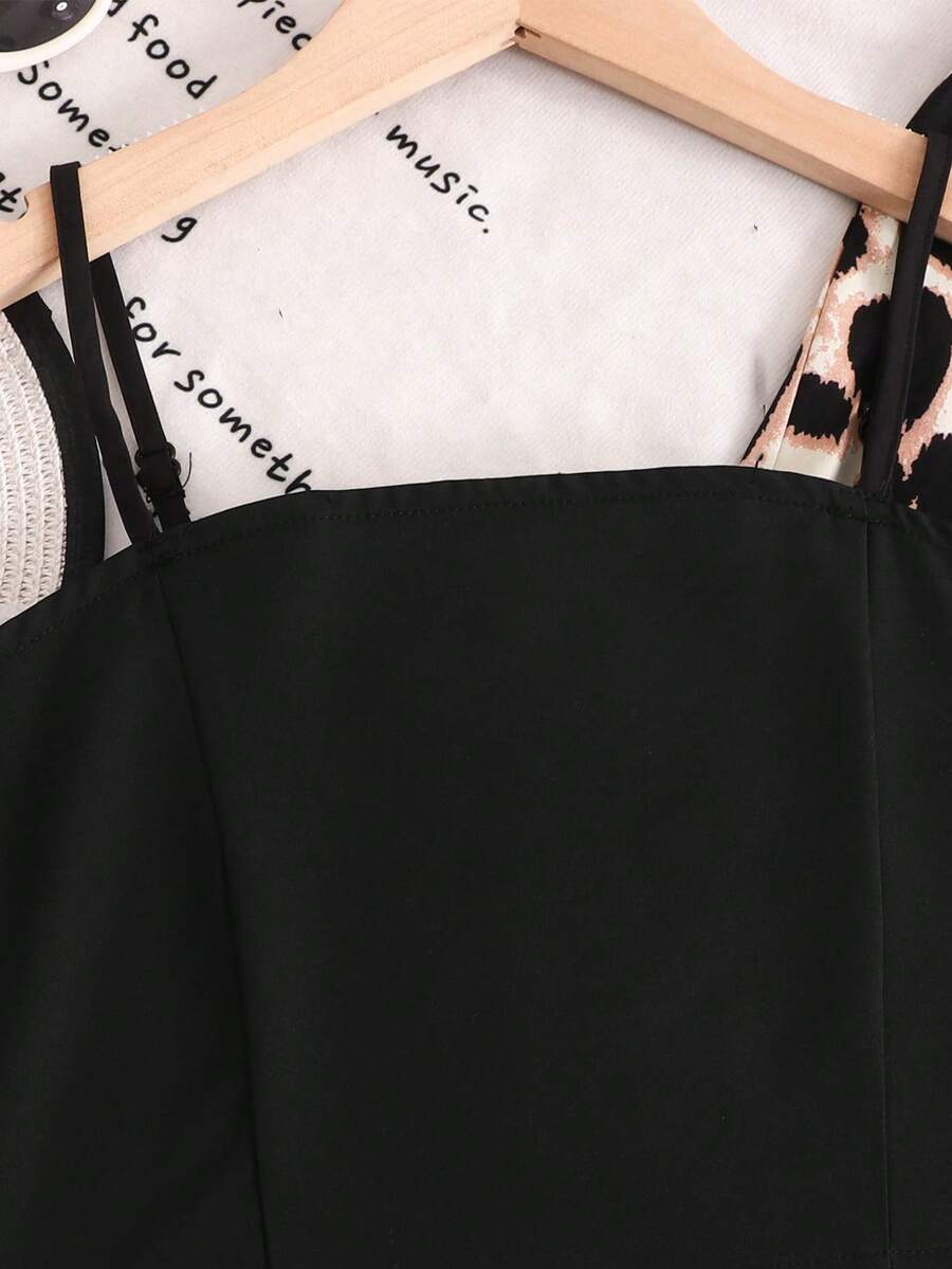 Tween girl wearing a black sleeveless spaghetti strap camisole top with 3D bow decor and matching leopard print wide leg long pants.
