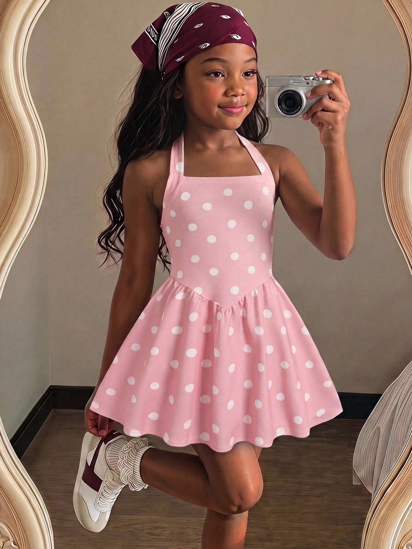 Black sleeveless halter polka dot mini dress for tween girls featuring a high waist and flared hem