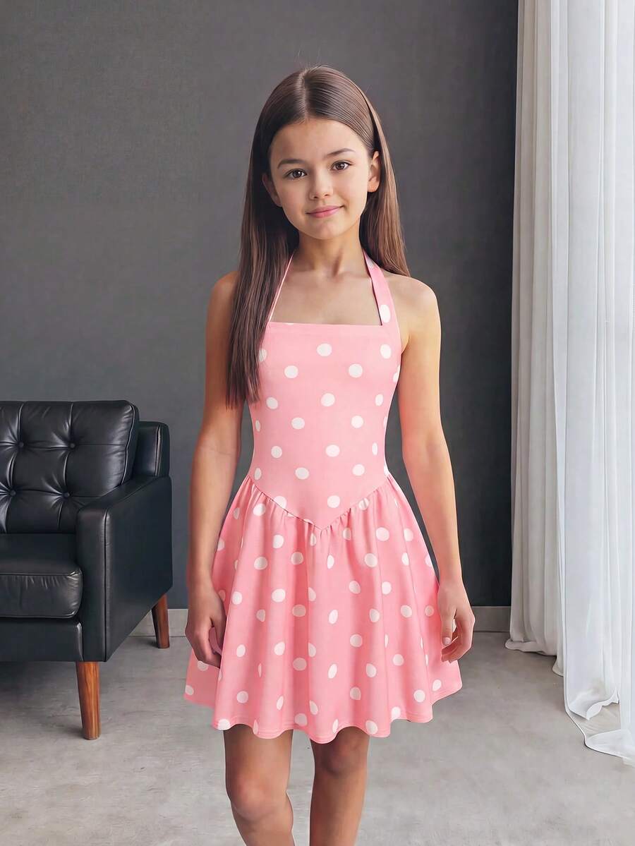 Black sleeveless halter polka dot mini dress for tween girls featuring a high waist and flared hem
