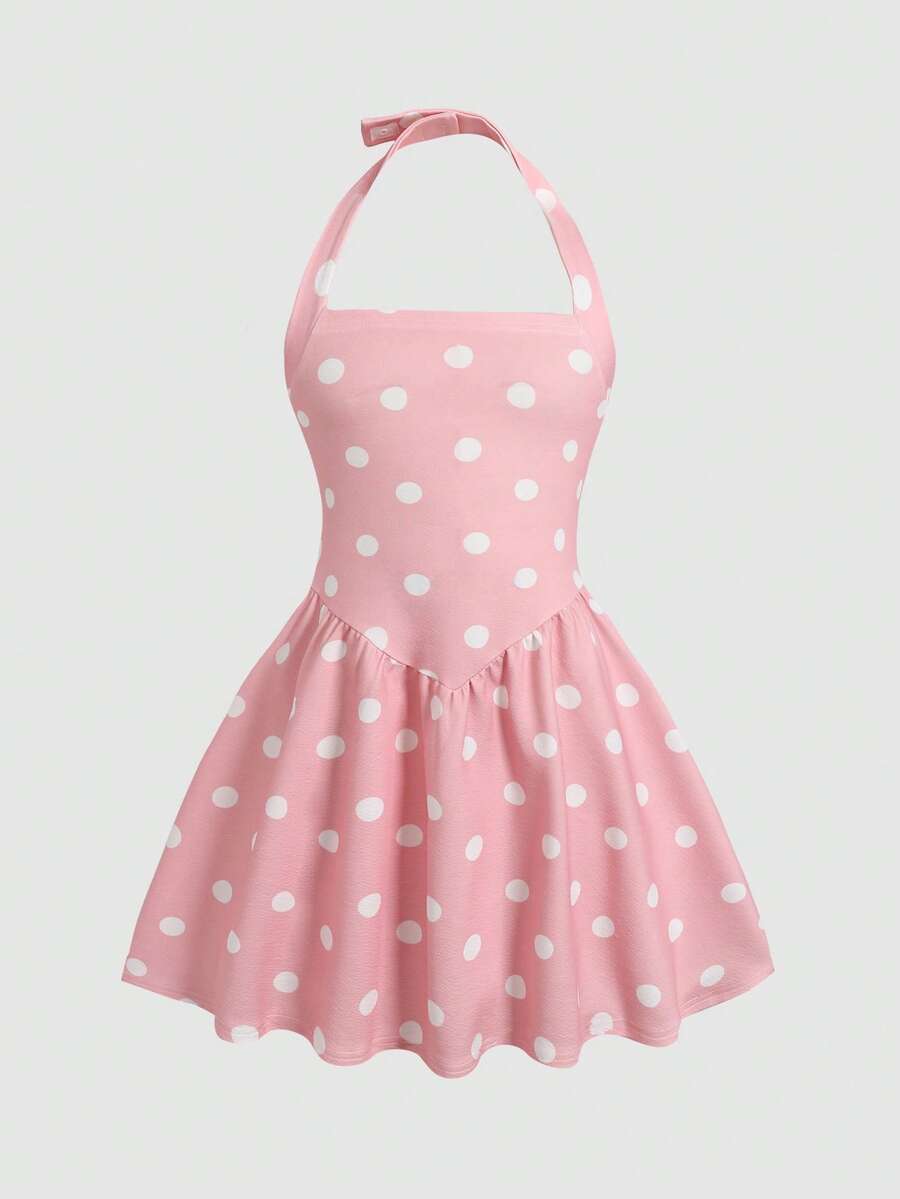 Black sleeveless halter polka dot mini dress for tween girls featuring a high waist and flared hem