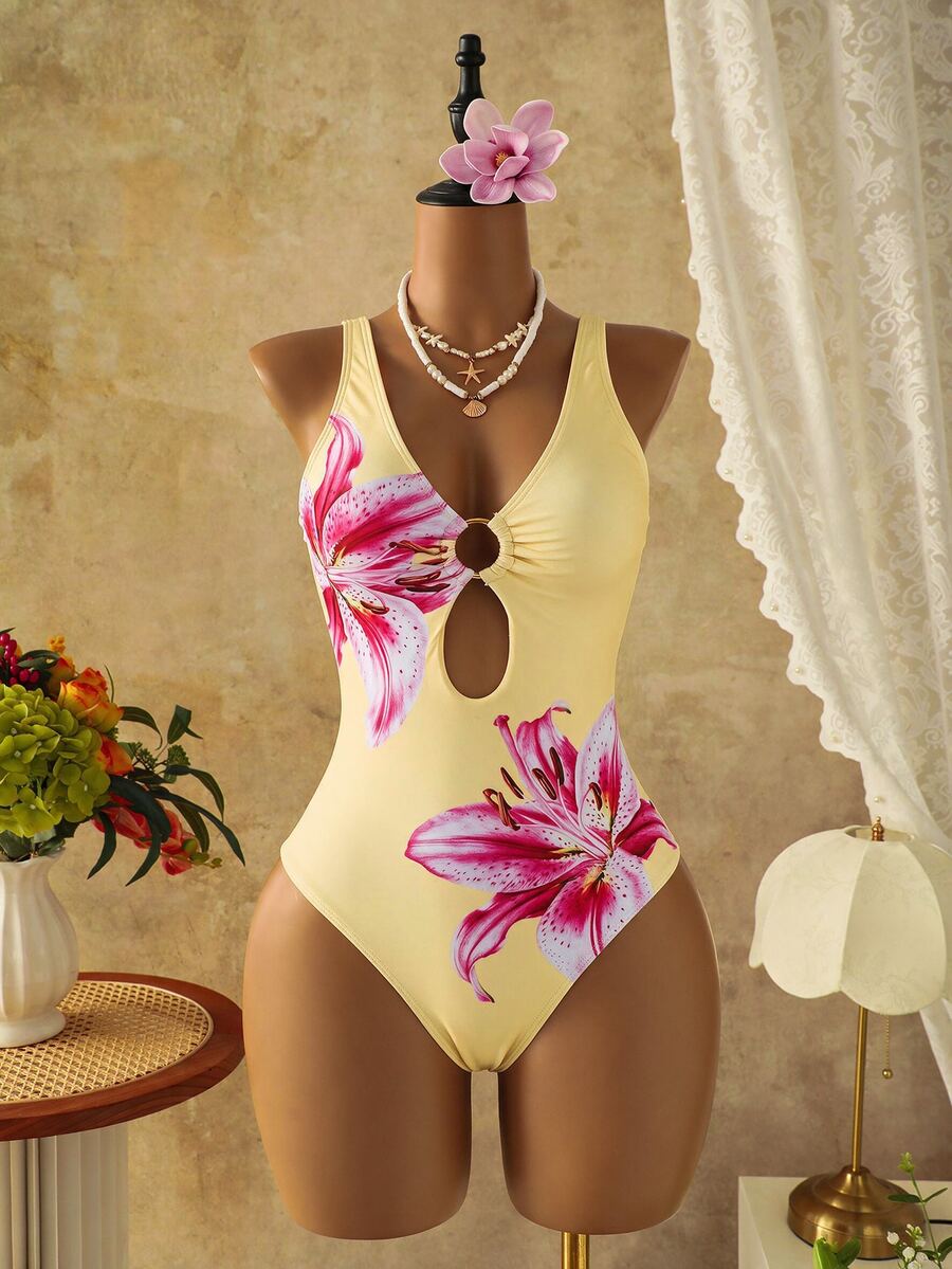 Women's black floral print plunge neck one-piece swimsuit featuring cut-out detail paired with a matching knee-length mesh cover-up skirt