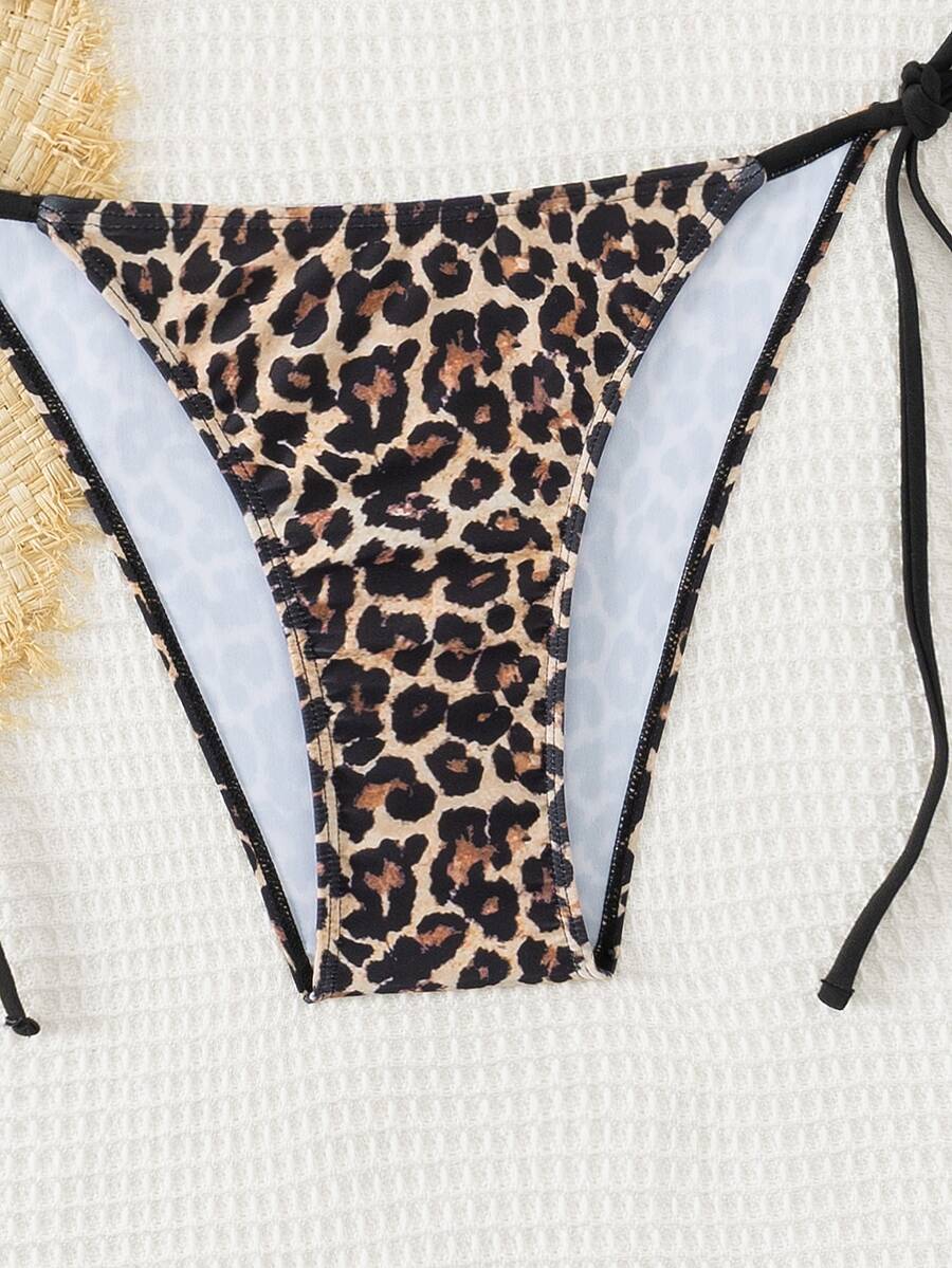 Women's black two-piece bikini set featuring a halter neck with a colorful sun pendant, triangle cups, and high-cut tie-side bottoms.
