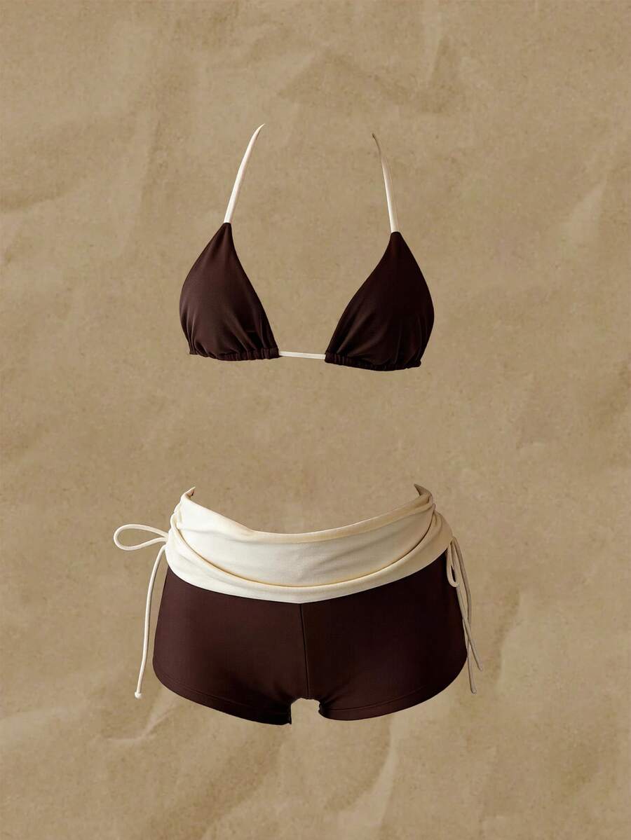 Women's halter triangle bikini top with knot detail paired with mid-waist colorblock swim shorts.
