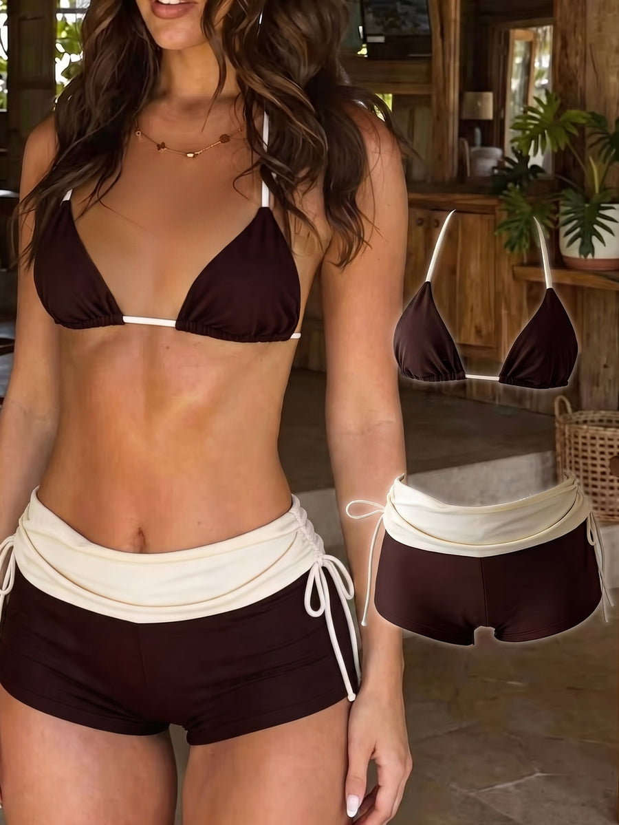 Women's halter triangle bikini top with knot detail paired with mid-waist colorblock swim shorts.